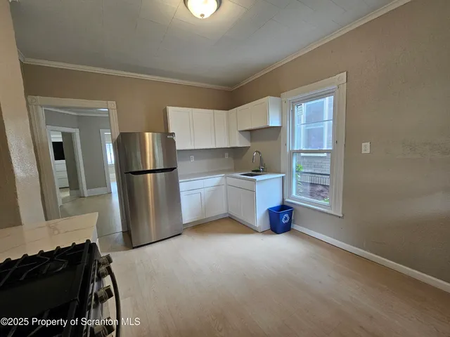 a kitchen with a refrigerator and a stove