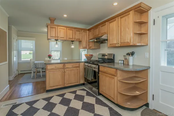 a kitchen with a checkered floor and white appliances