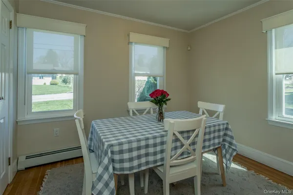 a view of a dining room with furniture and window