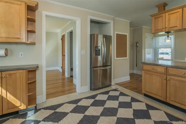 a kitchen with a checkered floor and white cabinets