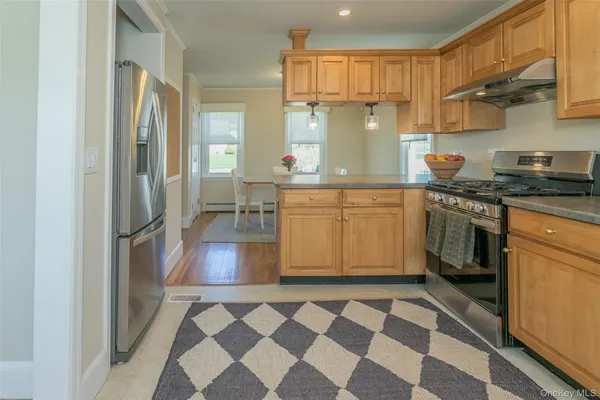 a kitchen with stainless steel appliances granite countertop a sink stove and refrigerator