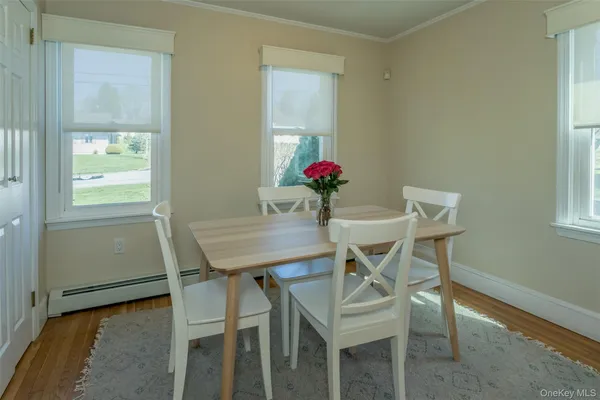 a view of a dining room with furniture and a window