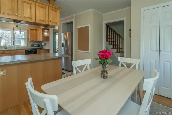 a dining room with furniture and wooden floor