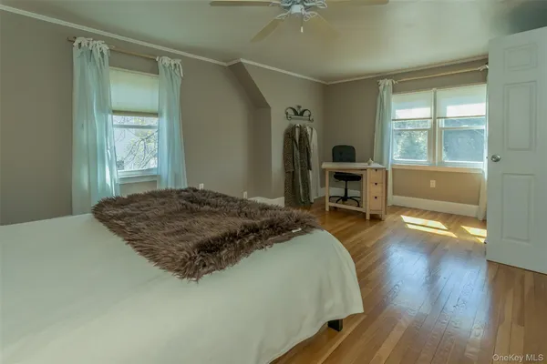 a bedroom with a bed and a large window