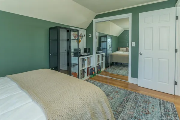 a bedroom with a bed and a walk in closet