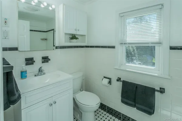 a bathroom with a sink toilet and mirror