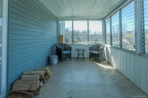 a view of work space with furniture and windows