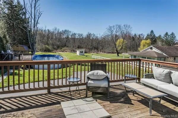 a view of a roof deck with wooden floor and fence