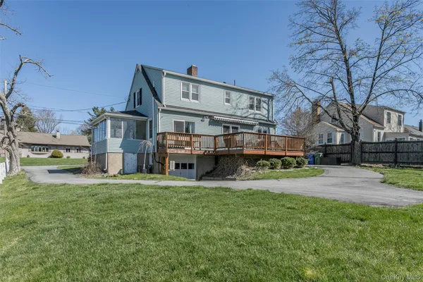 a view of a house with a big yard and sitting area