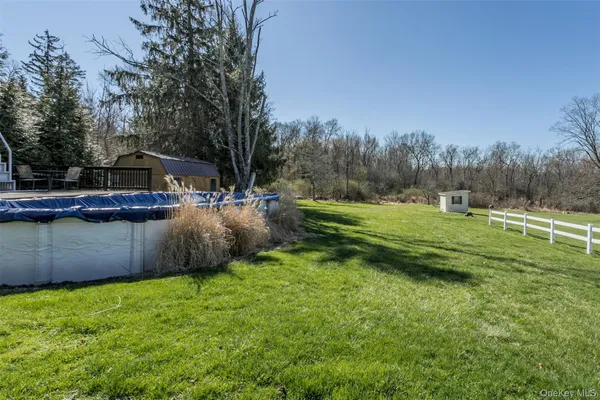 a view of a backyard with large trees