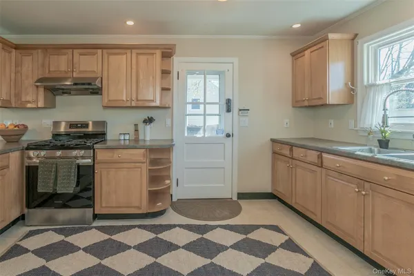 a kitchen with a stove a sink and a refrigerator
