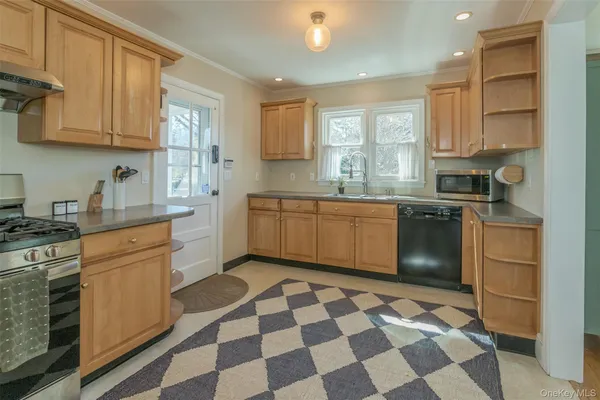 a kitchen with stainless steel appliances granite countertop a sink and cabinets