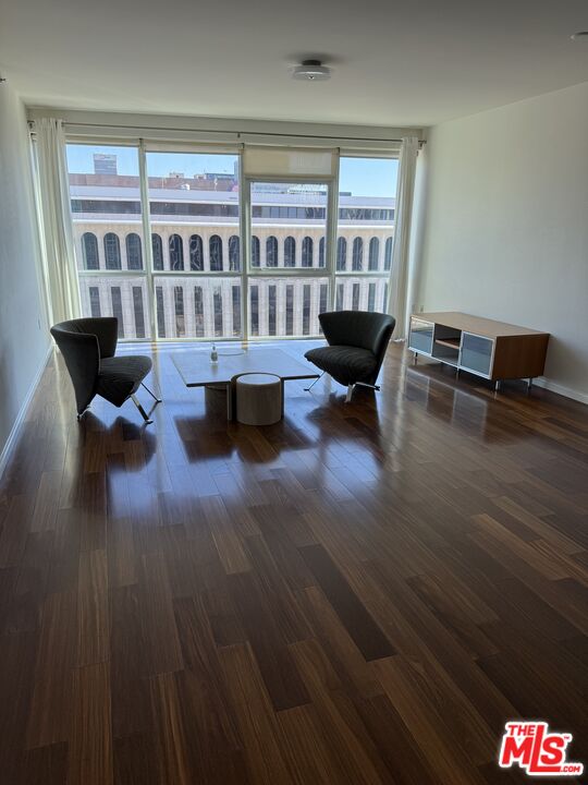 3785 Wilshire Boulevard, Unit 1504 Los Angeles, CA 90010 - Photo 2 of 9 a living room with furniture and a large window