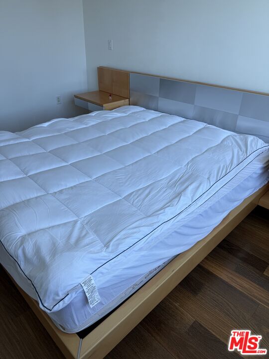 3785 Wilshire Boulevard, Unit 1504 Los Angeles, CA 90010 - Photo 6 of 9 a bedroom with a bed and dresser