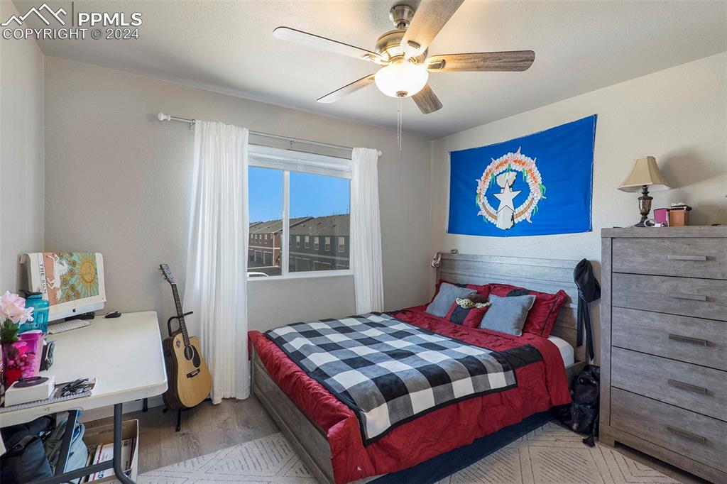 4346 Yellow Dock Point Colorado Springs, CO 80911 - Photo 13 of 20 a bedroom with a bed and a chandelier