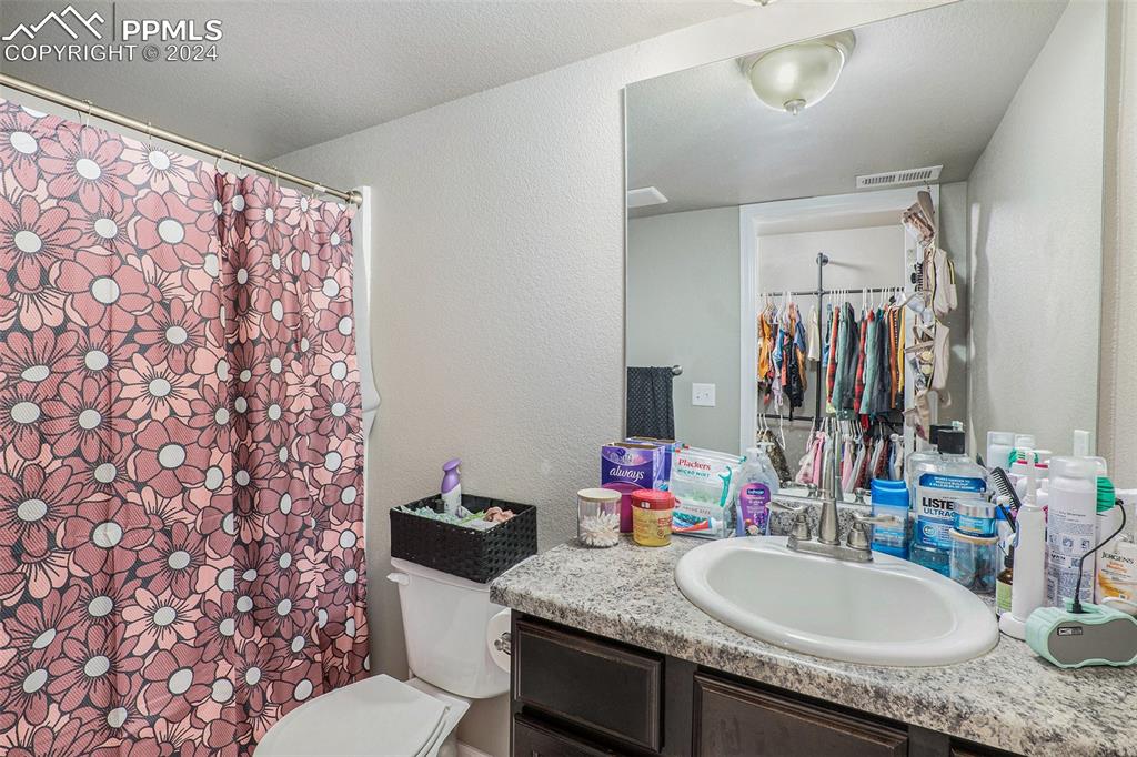 4346 Yellow Dock Point Colorado Springs, CO 80911 - Photo 20 of 20 a bathroom with a granite countertop sink and a mirror