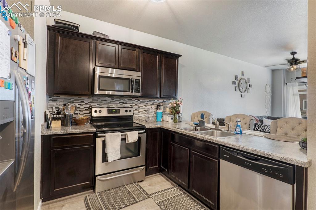 4346 Yellow Dock Point Colorado Springs, CO 80911 - Photo 5 of 20 a kitchen with a sink stove and microwave