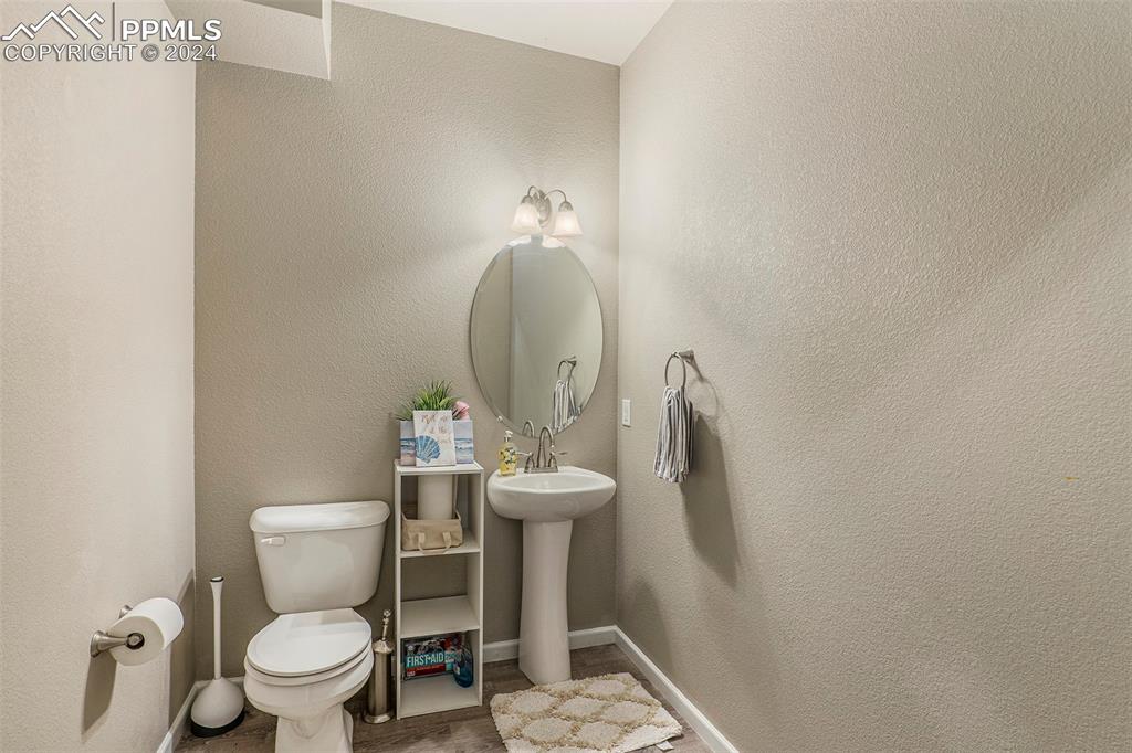 4346 Yellow Dock Point Colorado Springs, CO 80911 - Photo 7 of 20 a bathroom with a toilet sink and mirror