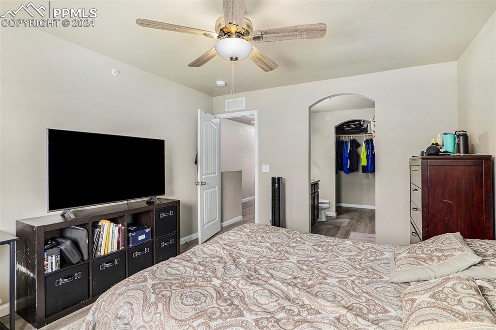 4346 Yellow Dock Point Colorado Springs, CO 80911 - Photo 10 of 20 a bedroom with a bed and a flat screen tv