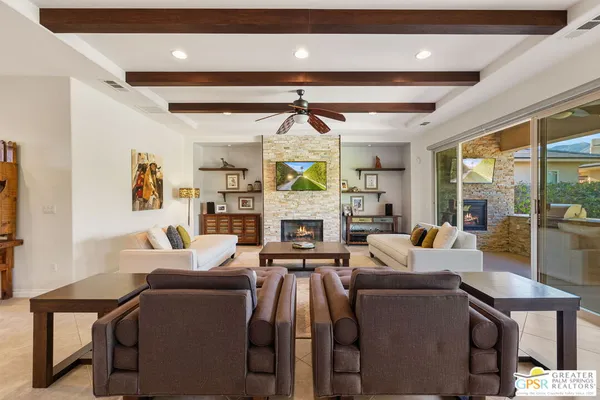 a living room with fireplace furniture and a chandelier