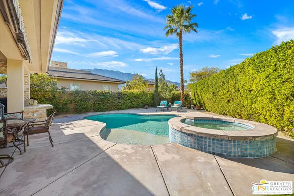 a view of a swimming pool with an outdoor seating