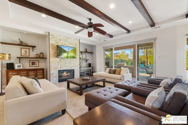 a living room with lots of furniture and a rug