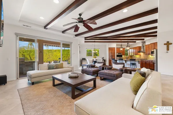 a living room with furniture fireplace and a large window