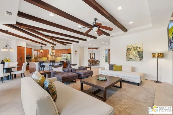 a dining room with furniture a chandelier and wooden floor