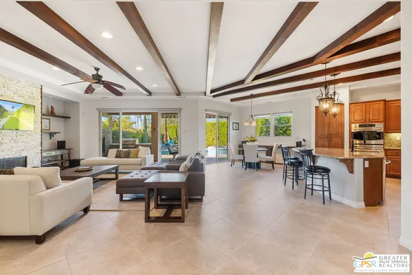 a living room with furniture and large windows