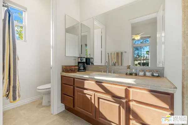 a kitchen with a refrigerator a sink and chandelier
