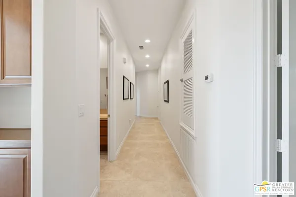 a view of a hallway with wooden shelves
