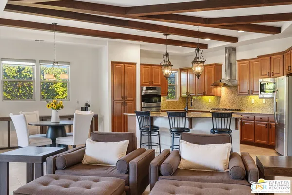 a living room with fireplace furniture and a chandelier