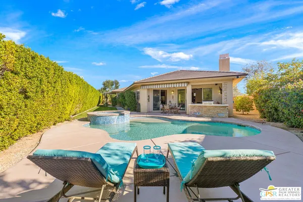 a view of house with swimming pool yard fire pit and outdoor seating