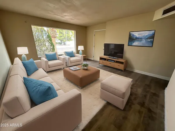 a living room with furniture and a flat screen tv