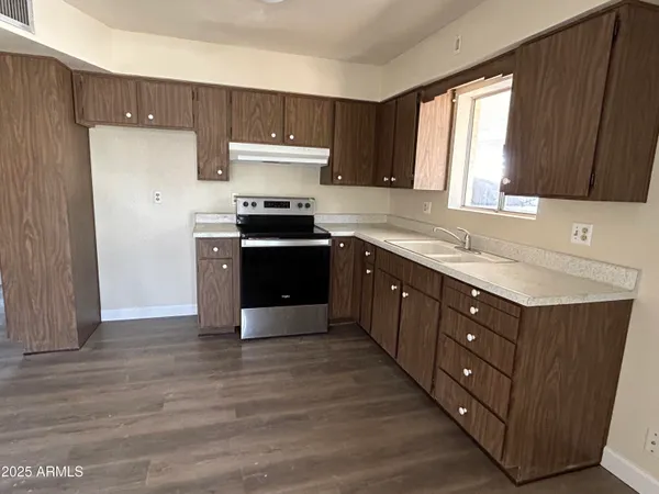 a kitchen with wooden cabinets and a sink