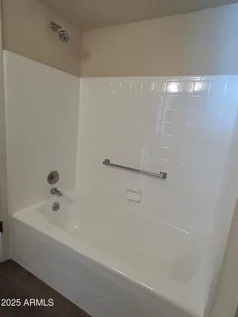 a bathroom with a shower and a bath tub