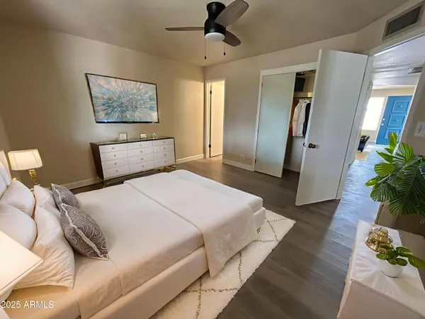 a bedroom with a bed and a potted plant