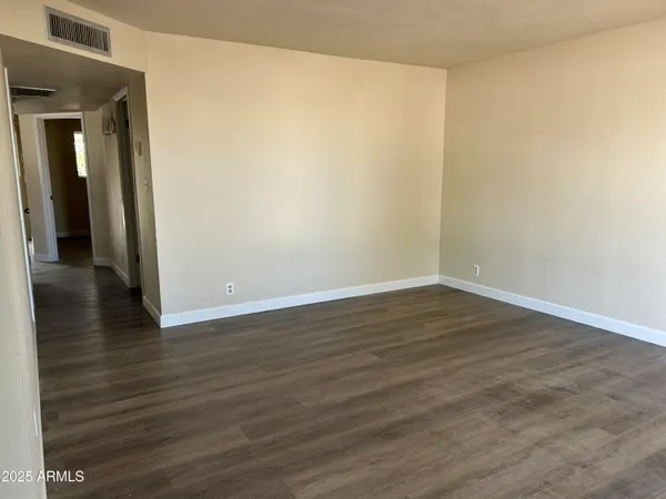 a view of a room with wooden floor