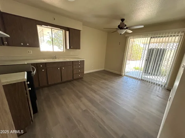 a open kitchen with wooden floor and a window