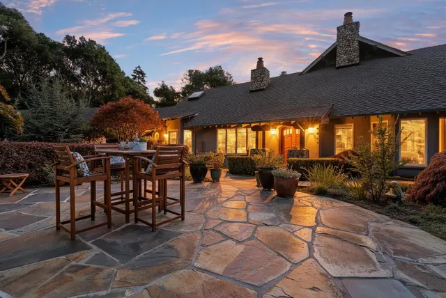a view of a patio with dining table and chairs with a barbeque grill and couches