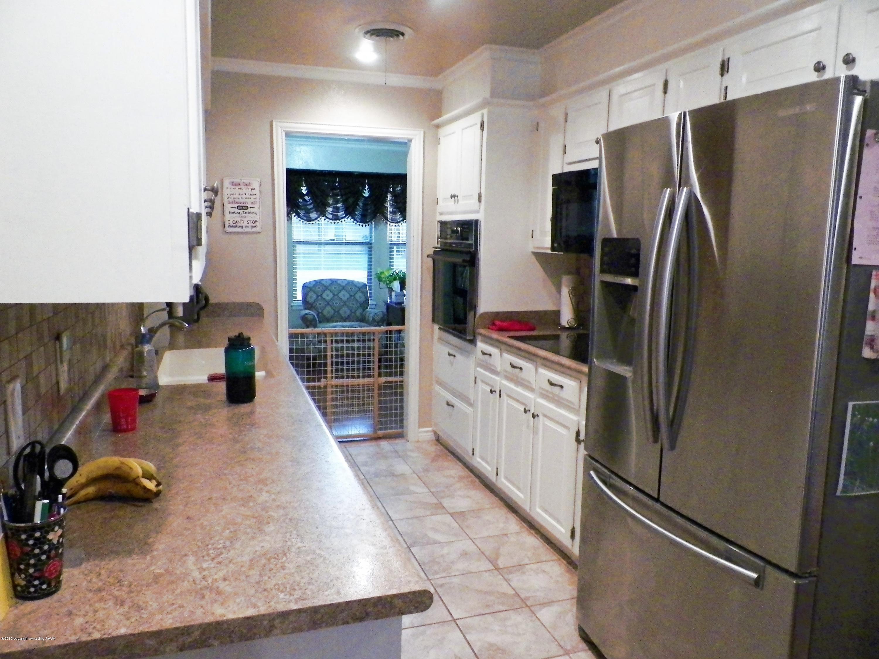 7100 Jameson Road Amarillo, TX 79106 - Photo 3 of 6 a kitchen with stainless steel appliances granite countertop a refrigerator and a sink