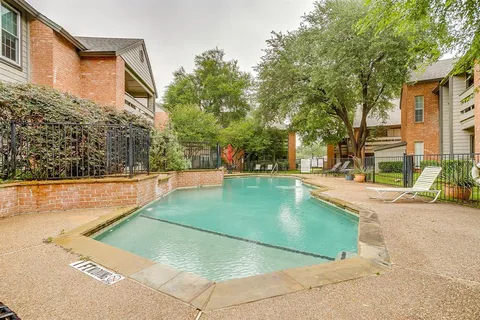 a swimming pool with outdoor seating and yard