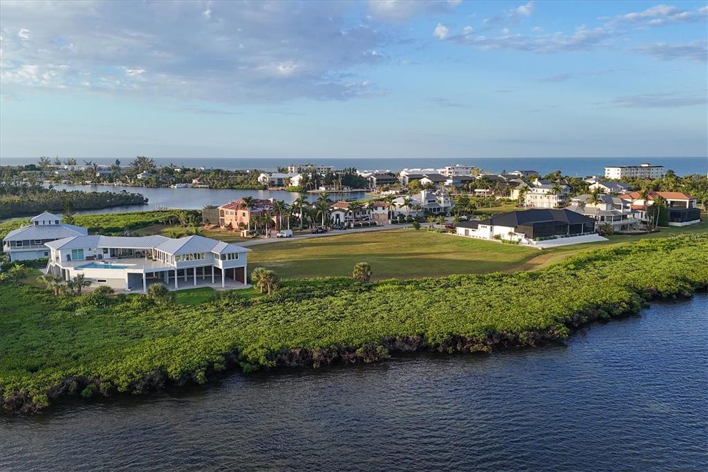 5248 The Pointe Englewood, FL 34223 - Photo 16 of 20 an aerial view of a city with lots of residential buildings ocean and mountain view in back