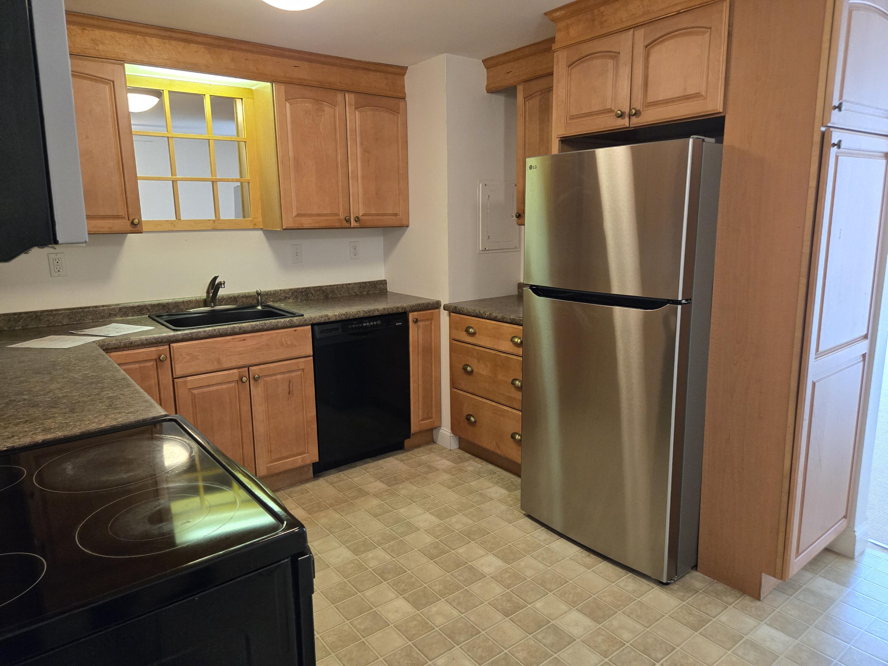 307 West Main Street, Unit 7 Hyannis, MA 02601 - Photo 2 of 15 a kitchen with stainless steel appliances granite countertop a refrigerator and a sink