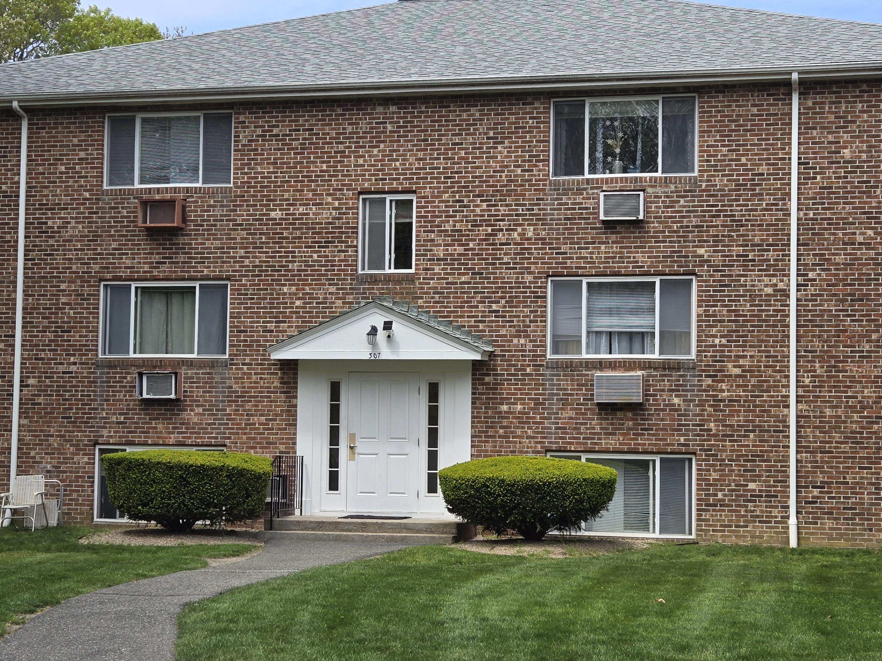 307 West Main Street, Unit 7 Hyannis, MA 02601 - Photo 5 of 15 a front view of a house with a yard