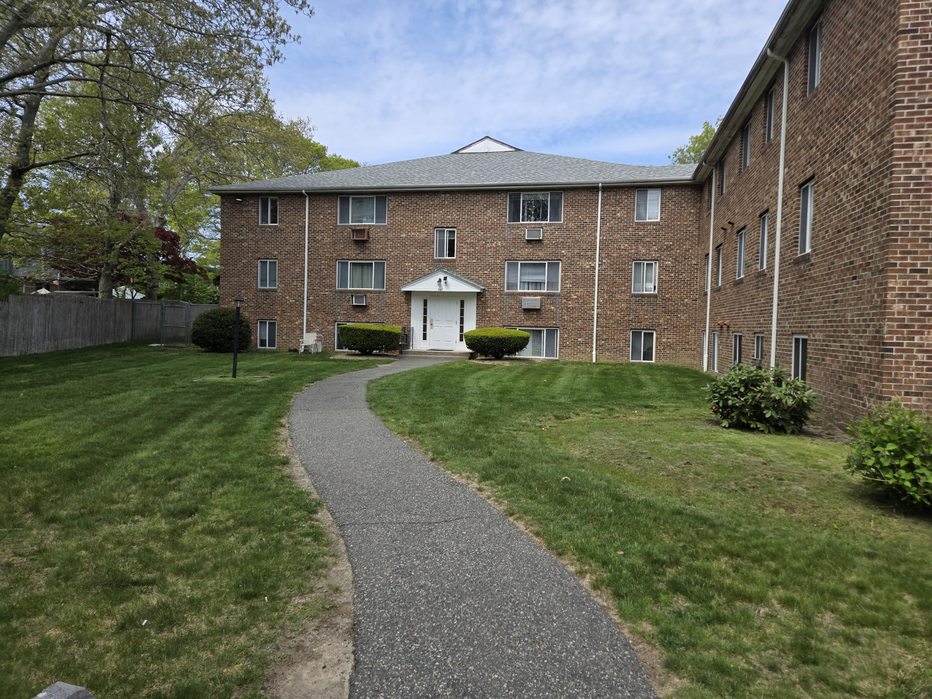 307 West Main Street, Unit 7 Hyannis, MA 02601 - Photo 6 of 15 a front view of a house with garden