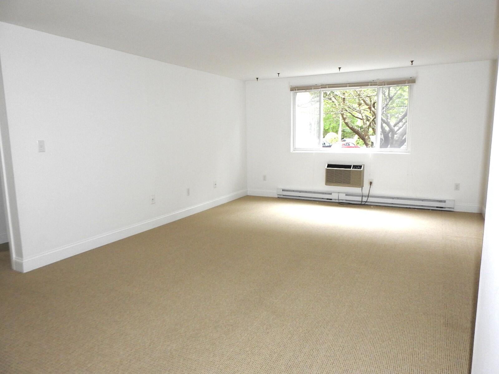 307 West Main Street, Unit 7 Hyannis, MA 02601 - Photo 7 of 15 an empty room with windows