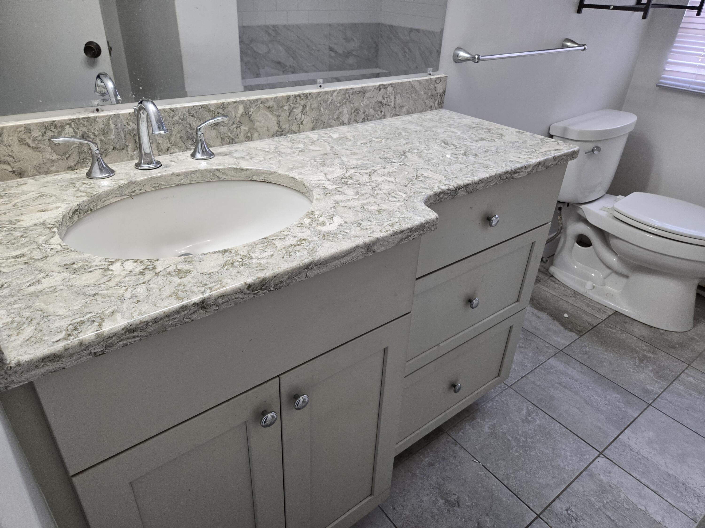 307 West Main Street, Unit 7 Hyannis, MA 02601 - Photo 9 of 15 a bathroom with a granite countertop sink and a toilet