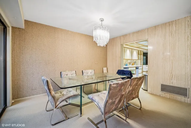 a view of a dining room with furniture and a chandelier