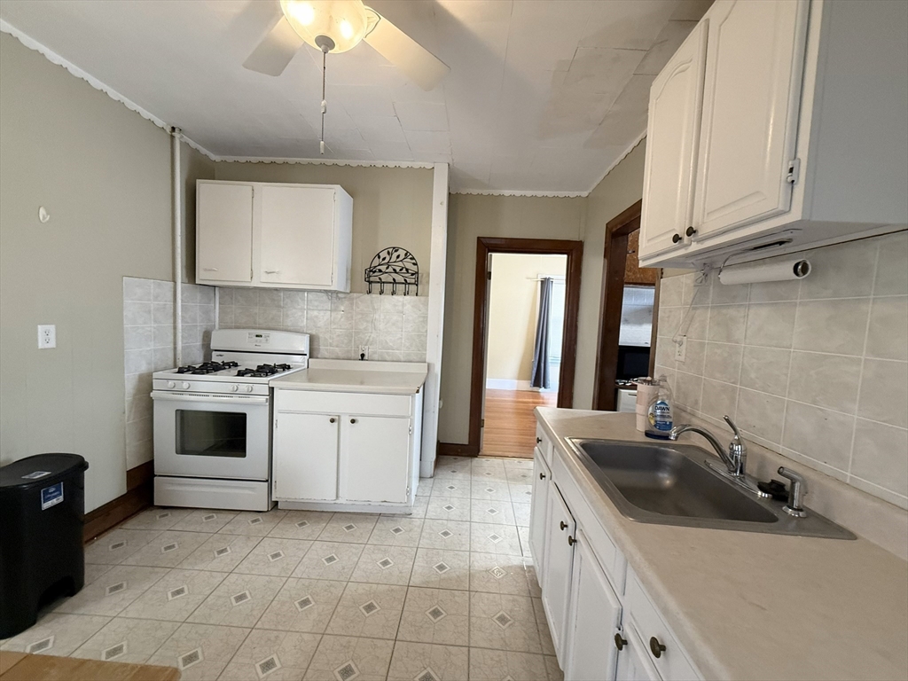 53 Litchfield Street, Unit 53 Boston, MA 02135 - Photo 12 of 14 a kitchen with a sink stove and cabinets